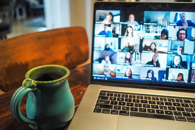 A laptop with people on Zoom